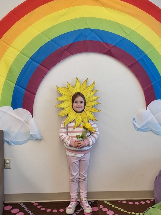 A student at Pottstown Area Garden Club poses as a flower during a visit from the Pottstown Area Garden Club. (Photo by Diane Jacobs)