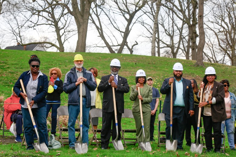A group of people with shovels and hats.