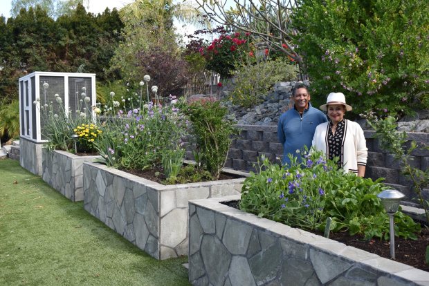 Winslow and Ramona Garnier in their vegetable garden that includes raised beds and a wide variety of vegetables and herbs that Ramona uses in her cooking. (Elizabeth Marie Himchak)