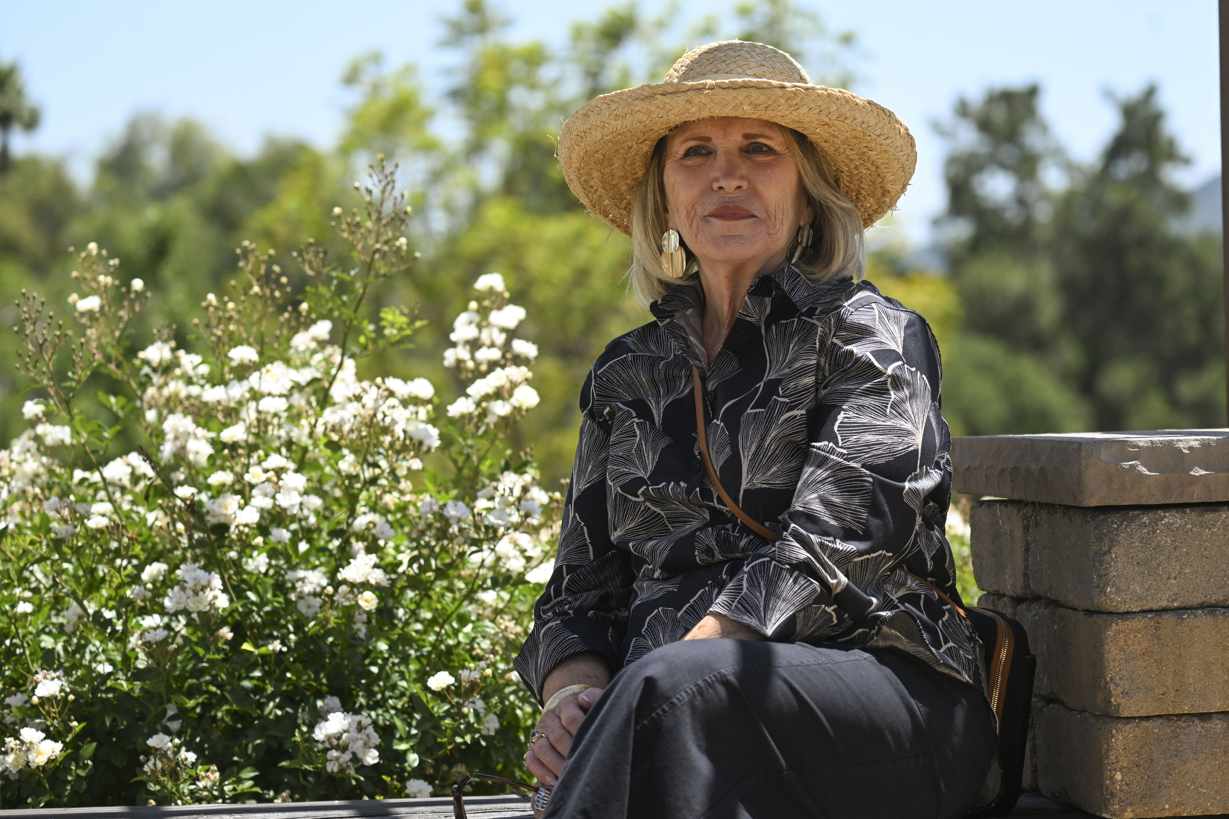 Susan Whitten, president of the Temecula Valley Rose Society, sits...