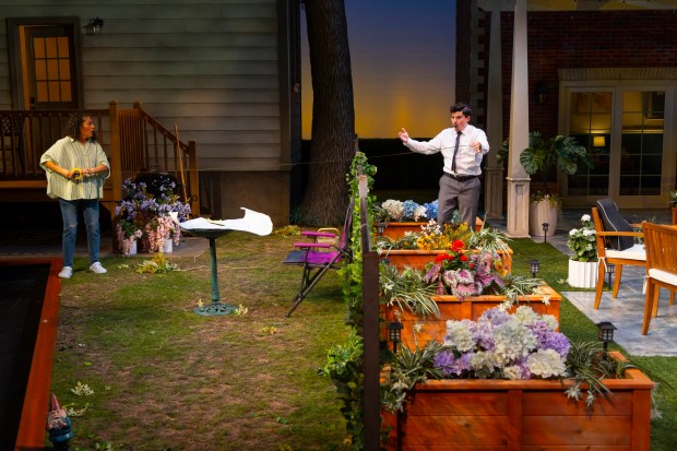 The del Valle couple and the offending fence of their neighbors the Butleys in "Native Gardens" at Hartford Stage. (T Charles Erickson)