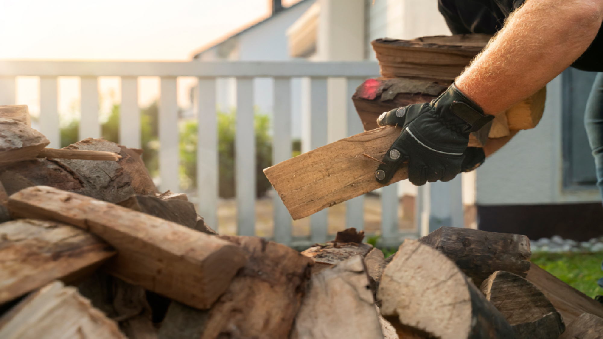 Person building a log pile