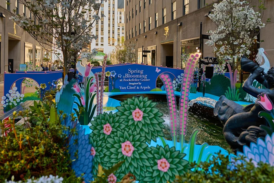 Spring-themed installation at Rockefeller Center featuring decorative flowers and a fountain.