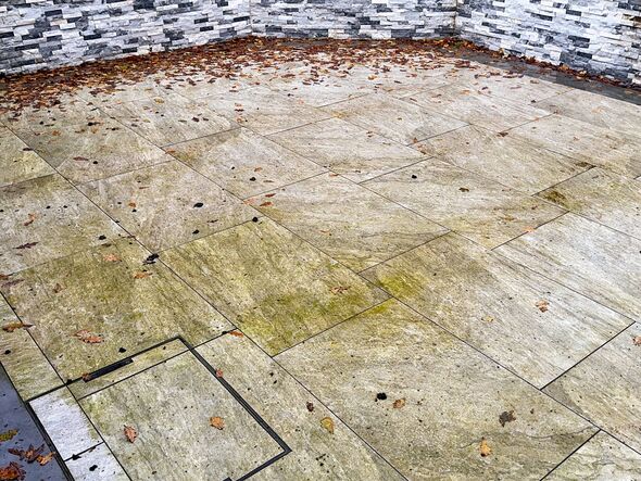 Garden patio with porcelain tiles discolured by bad weather in autumn. No people. Garden patio with porcelain tiles discolured by bad weather in autumn. No people.