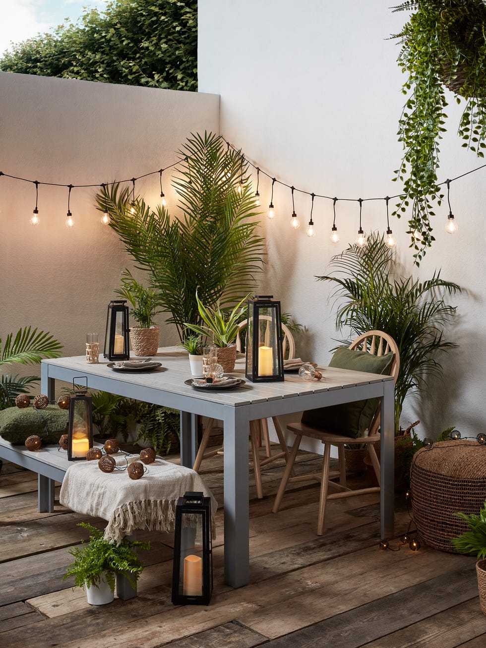 outdoor dining area with decorative lighting and plants outdoor dining area with decorative lighting and plants