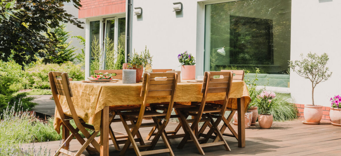 Mastering the art of al fresco dining in your garden this summer Lot of green plants in big beautiful garden with trendy furniture on the terrace