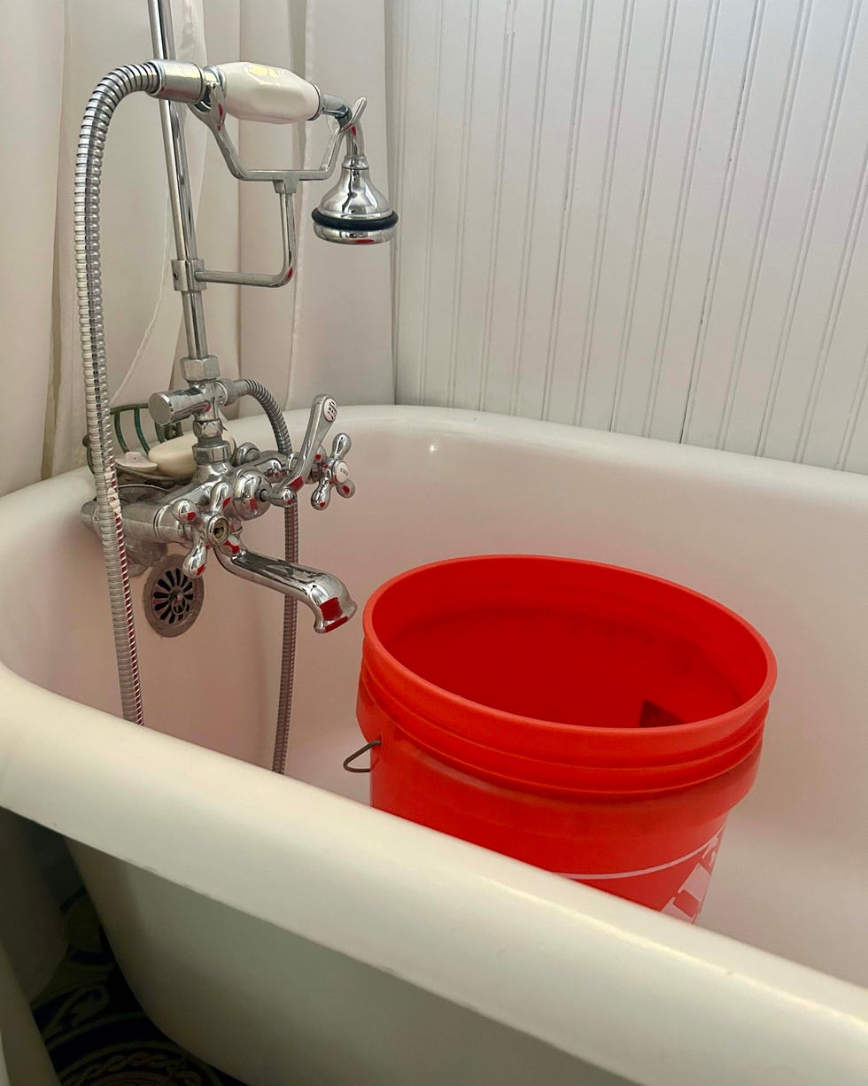 a bucket in a bathtub used to catch water