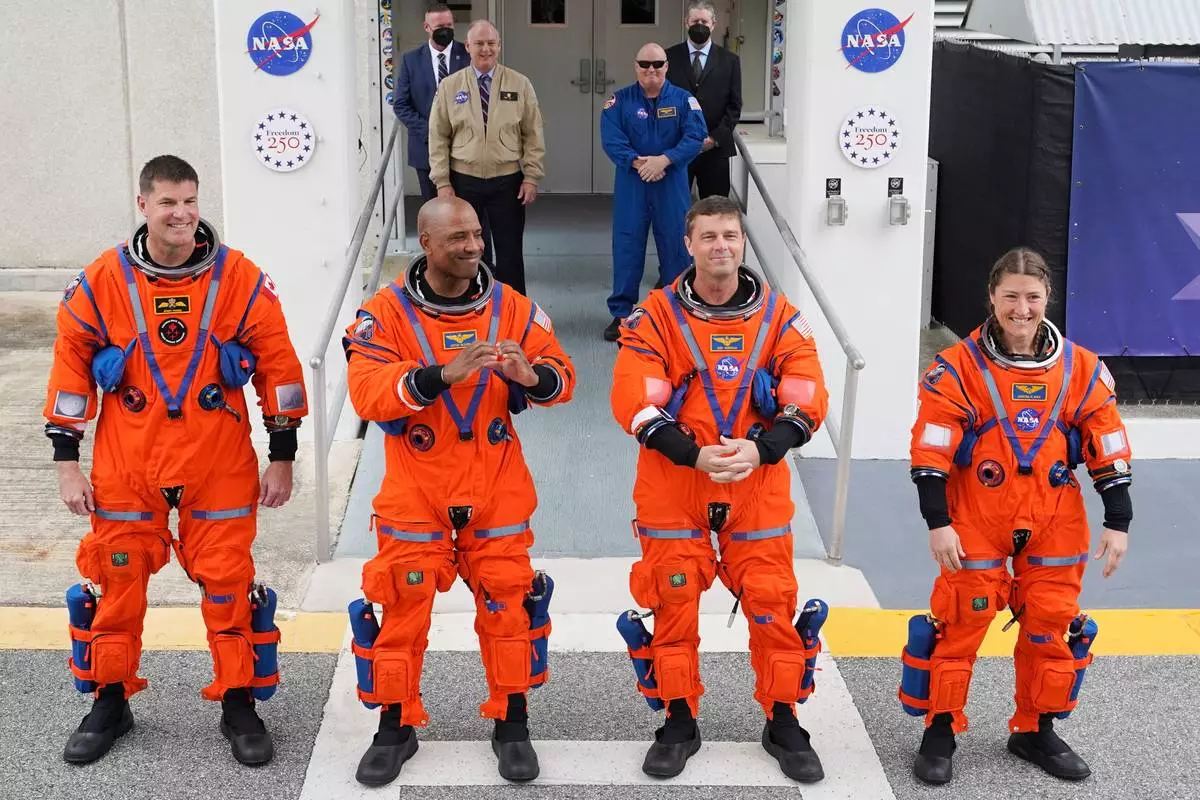 Astronauts, from left, Canadian Space Agency astronaut Jeremy Hansen, pilot Victor Glover, commander Reid Wiseman and mission specialist, Christina Koch leave the Operations and Checkout building on their way to Launch Pad 39B for a planned liftoff on NASA's Artemis II moon rocket at the Kennedy Space Center, Wednesday, April 1, 2026, in Cape Canaveral, Fla. (AP Photo/John Raoux)