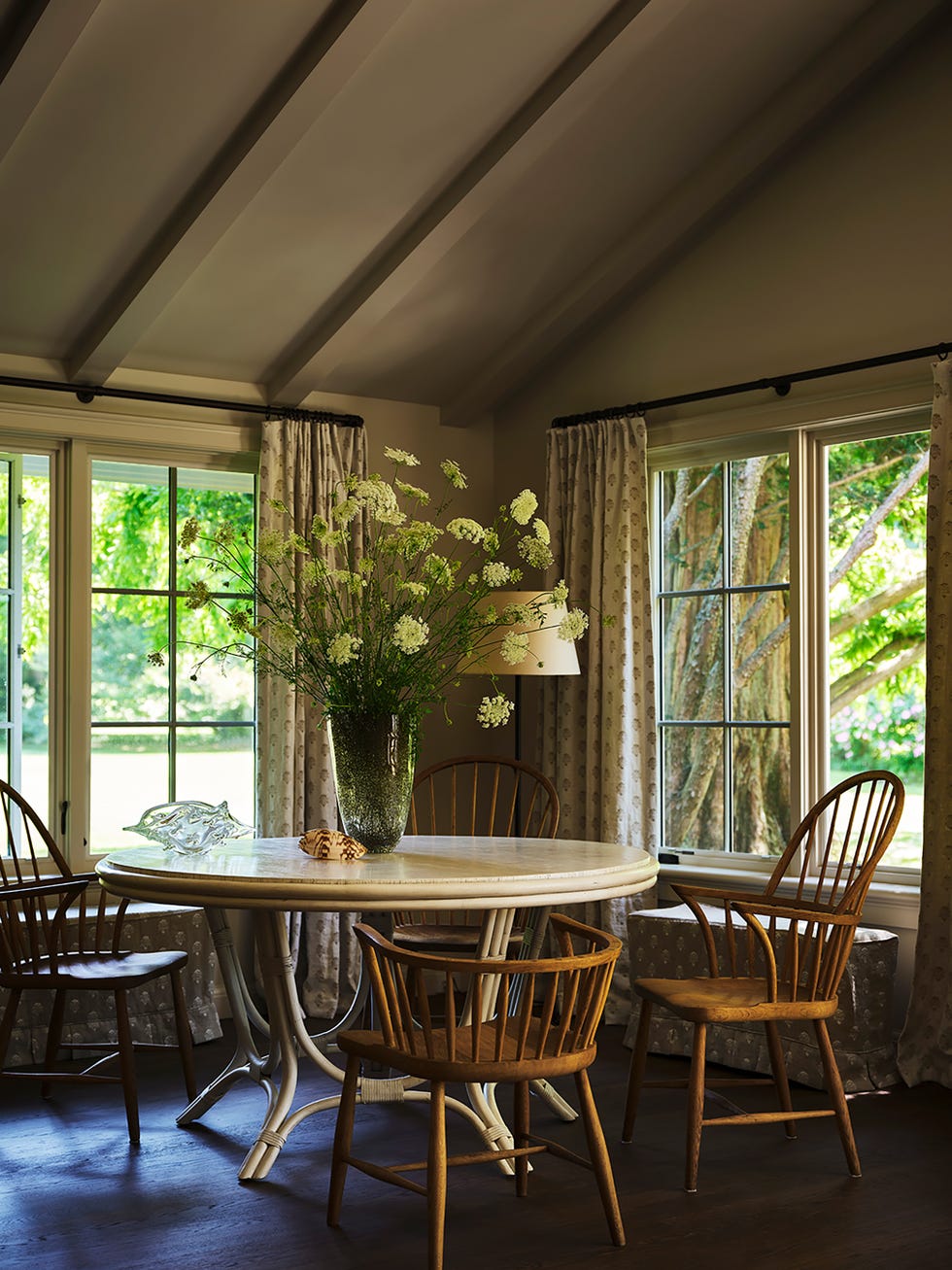 Cozy dining area with a round table and wooden chairs.
