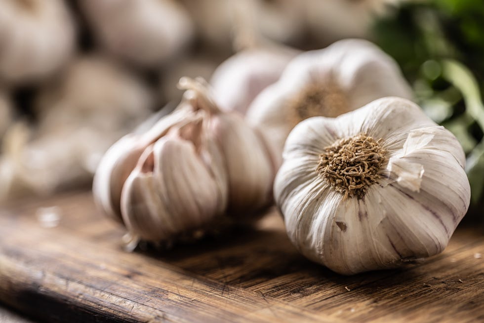 Organic garlic unpeeled ready to be used for cooking in the kitchen. organic garlic unpeeled ready to be used for cooking in the kitchen