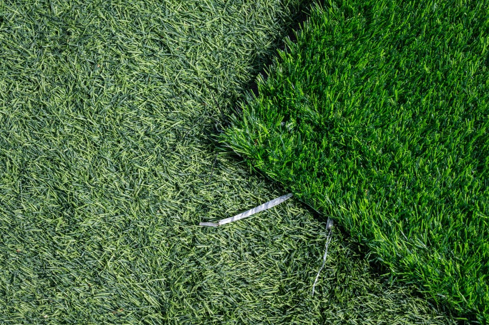 high angle view of unfinished green artificial turf used for covering sport arena or garden.