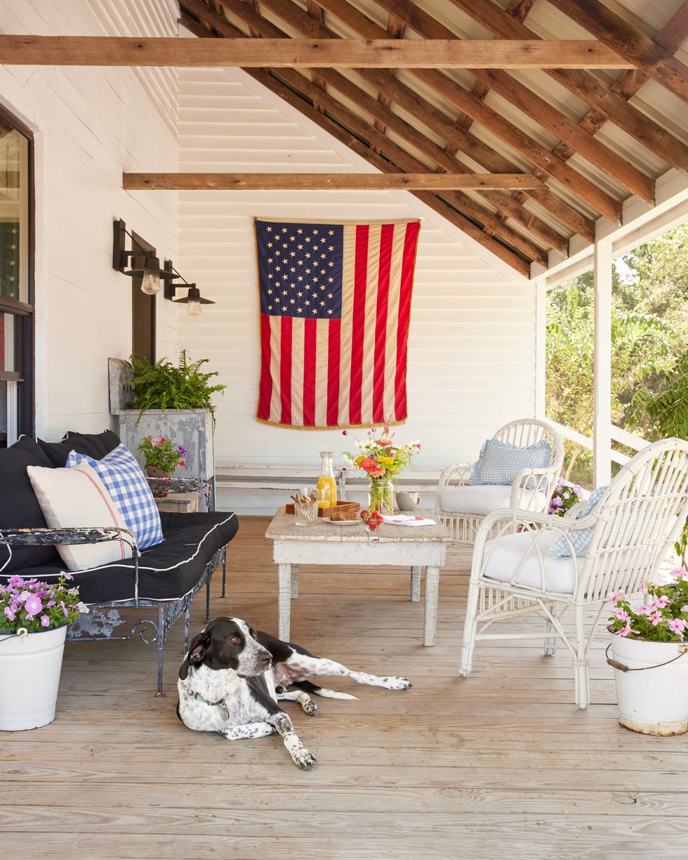 Texas Farmhouse Porch texas farmhouse porch with mixed furniture and a dog
