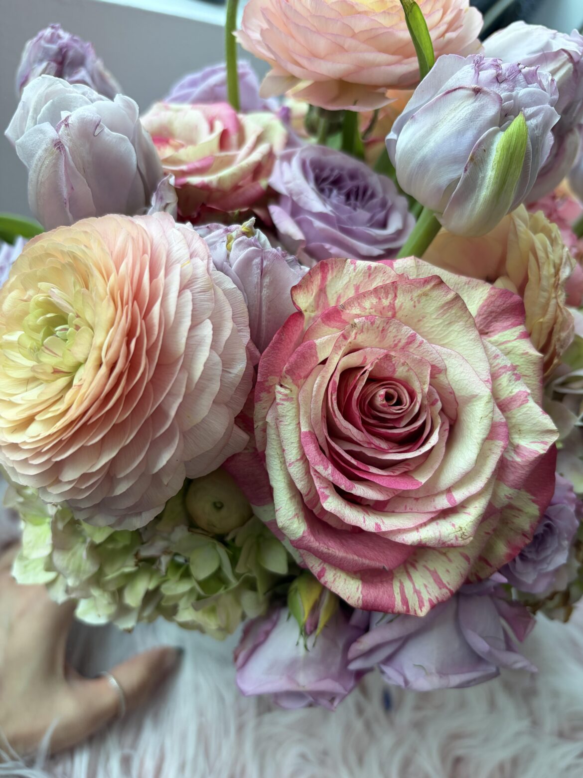 Striped rose with ranunculus in a pretty Easter bouquet