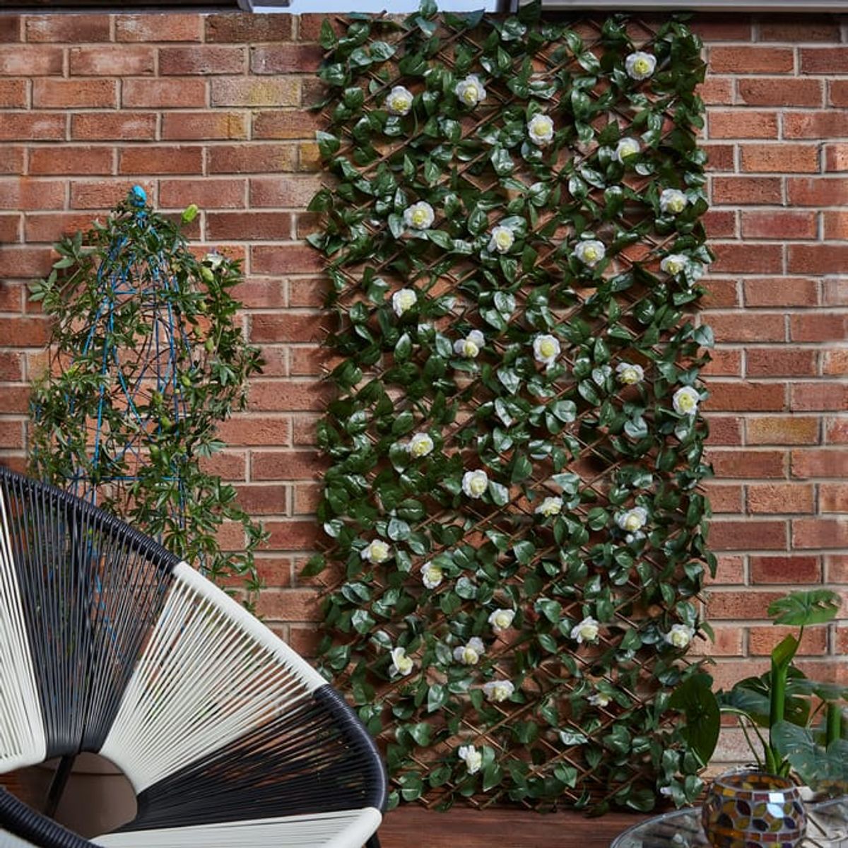 An image of an artificial wall trellis in a summer garden