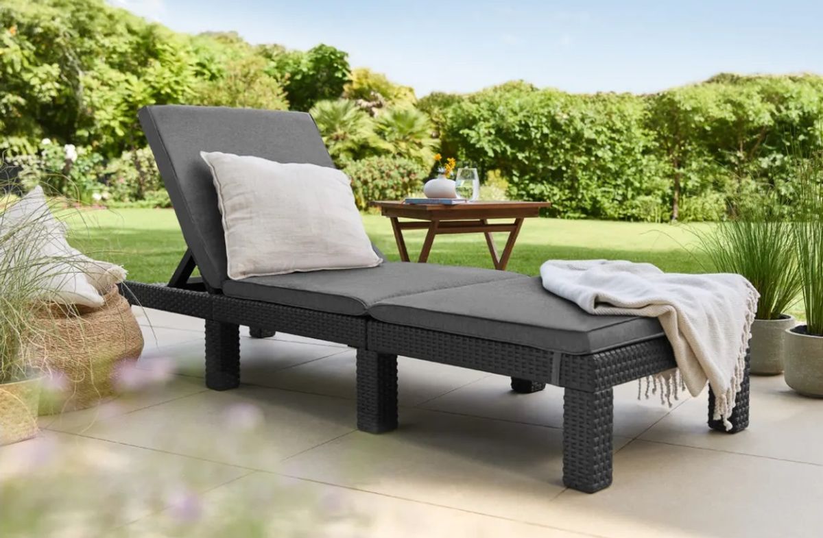 An image of a sun lounger in a garden setting