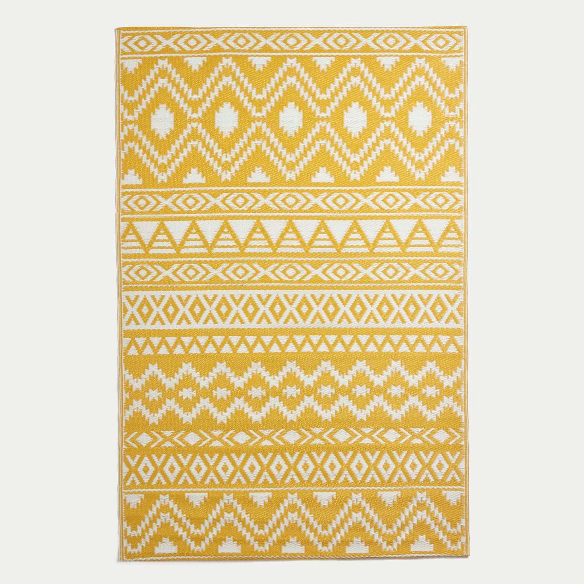A product shot of the yellow Aztec outdoor rug