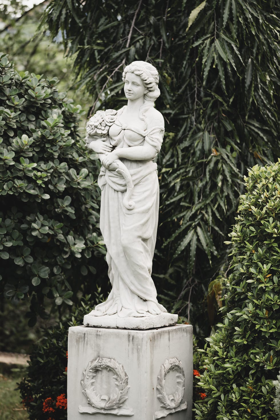 Statue of a young woman in the garden. Statue of a young woman in the garden.