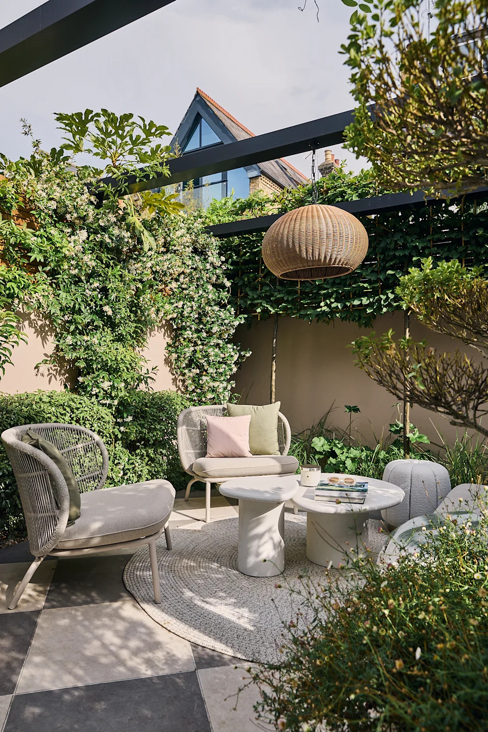 a modern garden filled with plants with a large checkerboard floor