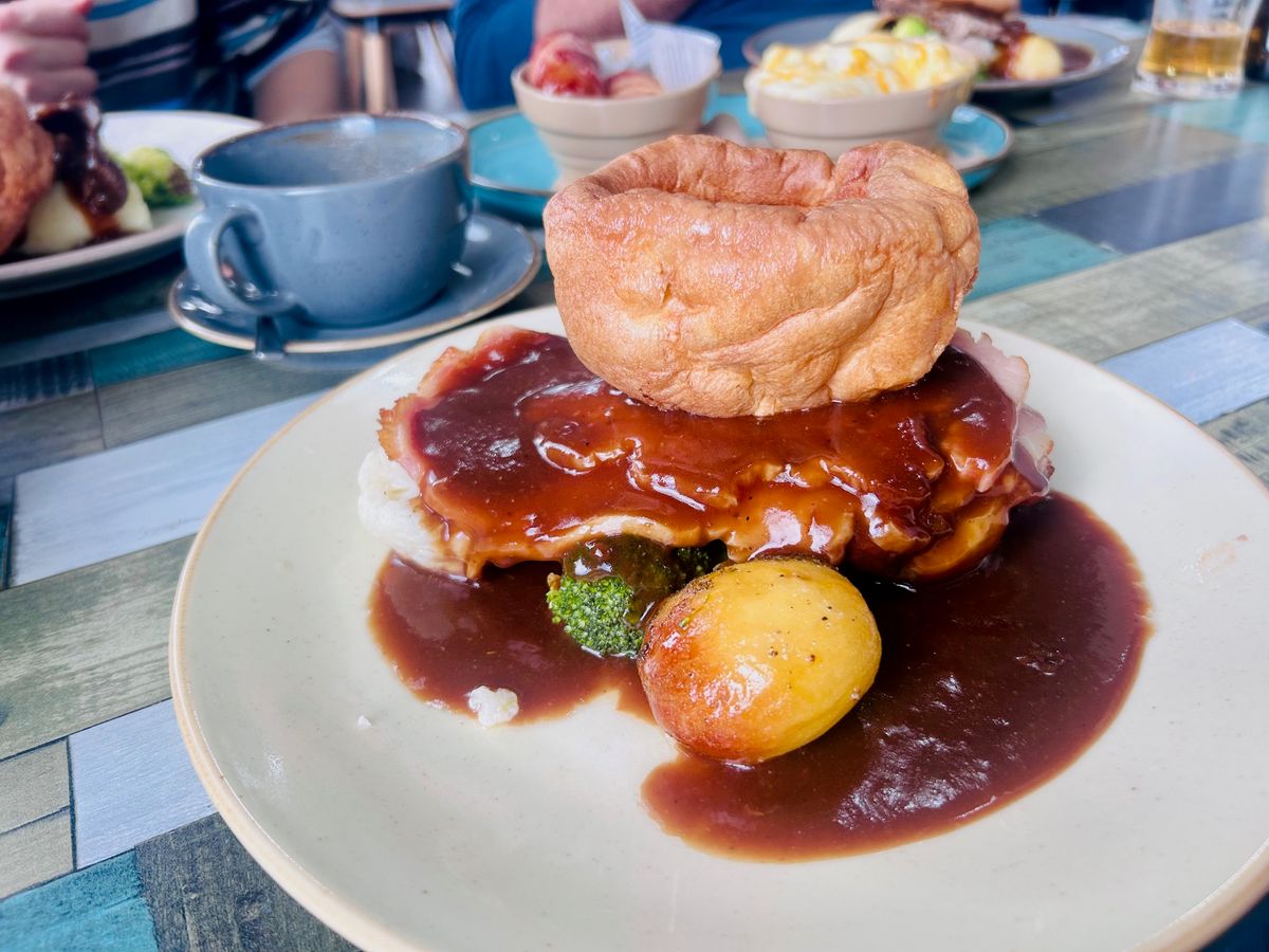 The roast dinner comes with roast potatoes, seasonal vegetables, mash, a meat of choice and is topped with a large Yorkshire pudding