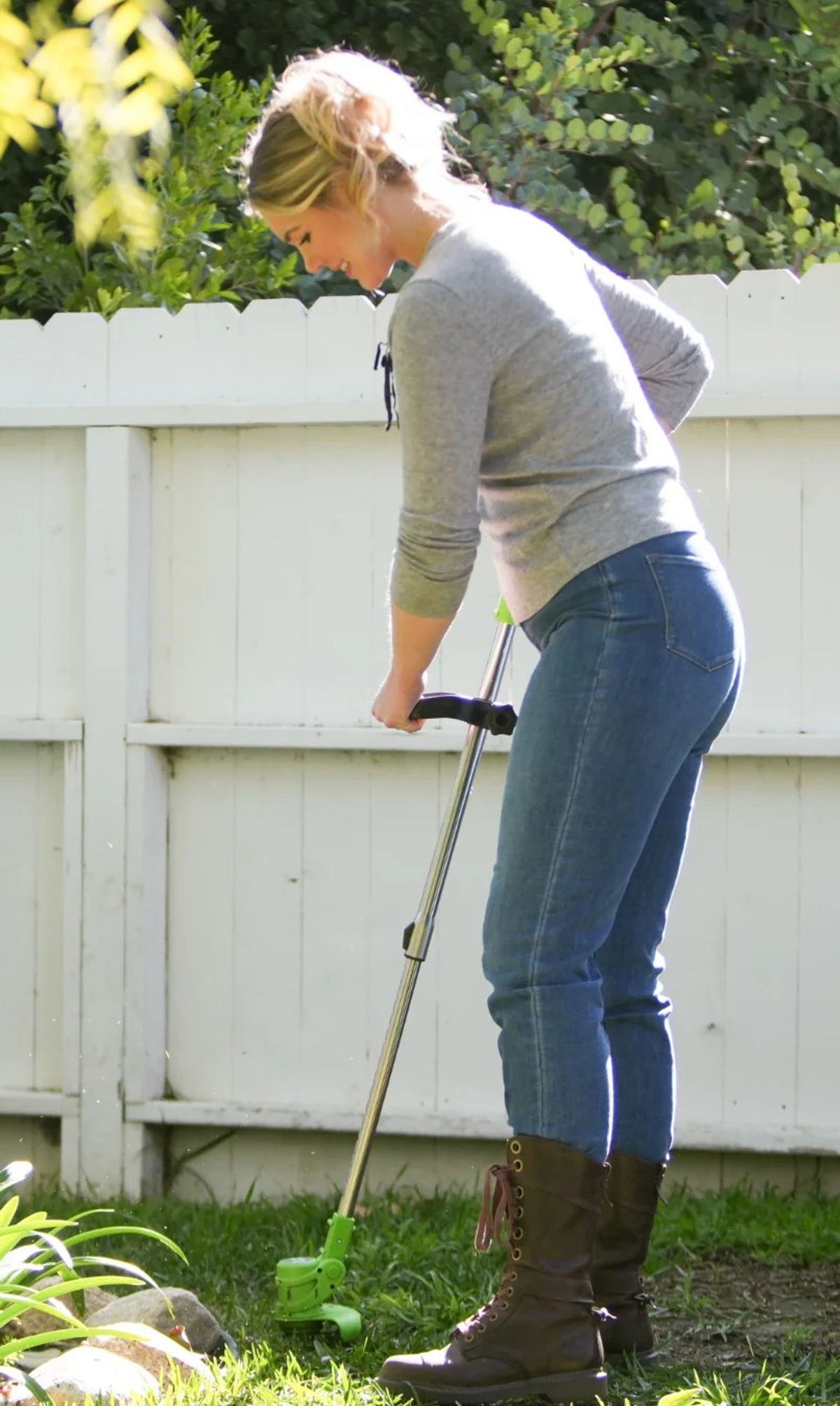 A woman using the Drew&Cole Lawn Barber