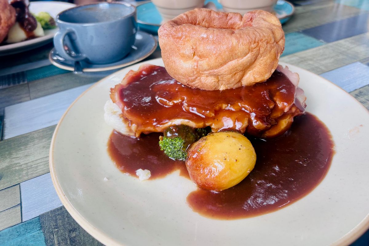 The roast dinner comes with roast potatoes, seasonal vegetables, mash, a meat of choice and is topped with a large Yorkshire pudding