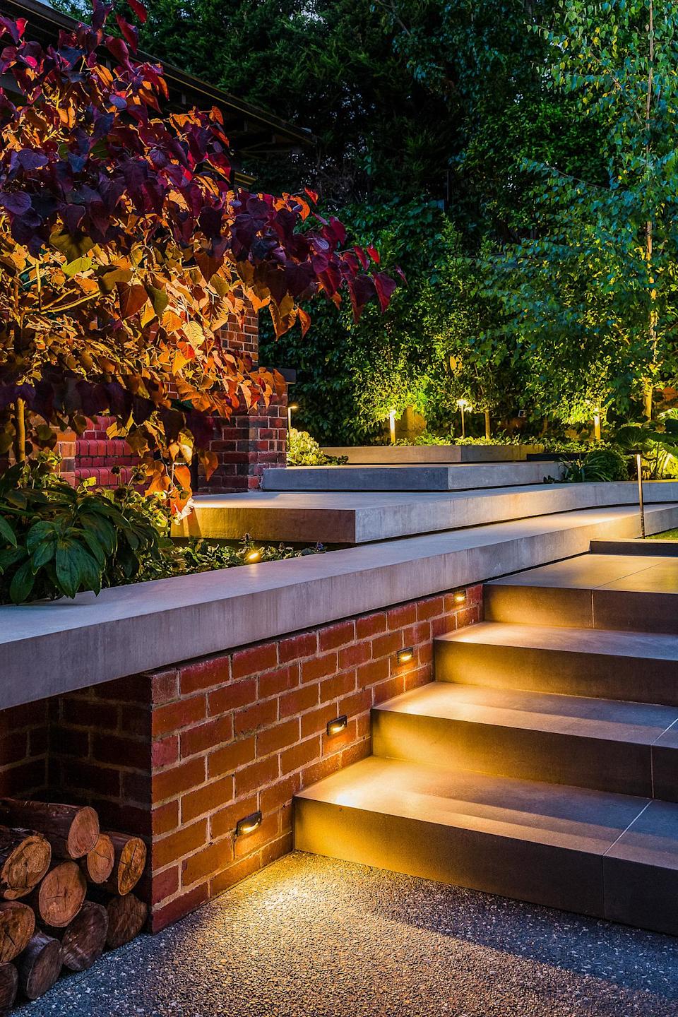 A garden with well-lit garden steps