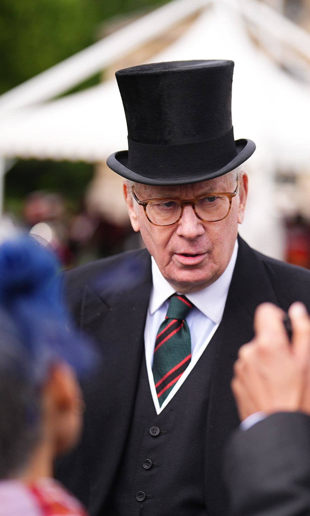 The Duke of Gloucester speaking to guests at a garden party