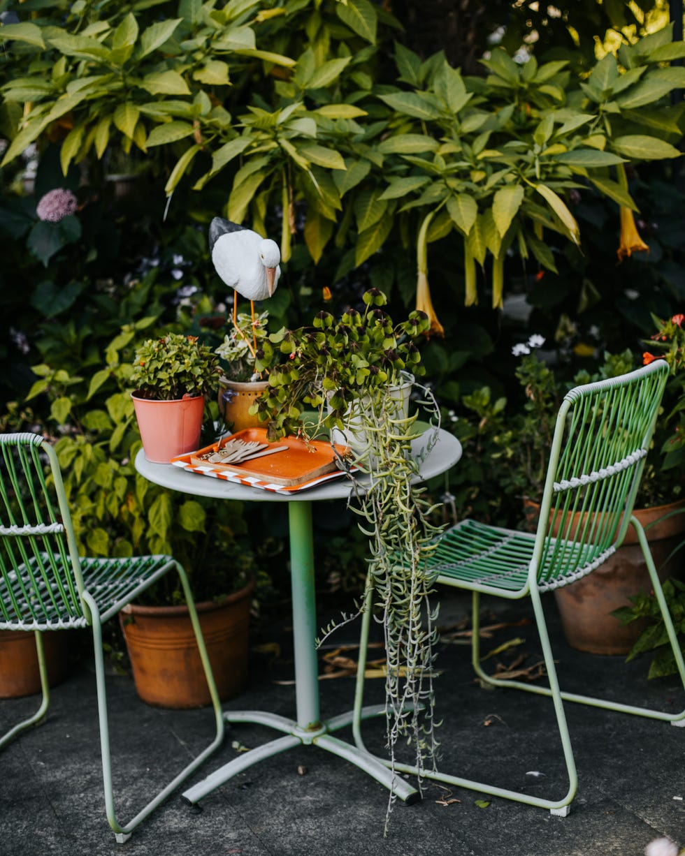 green garden furniture in a small garden. green garden furniture in a small garden.