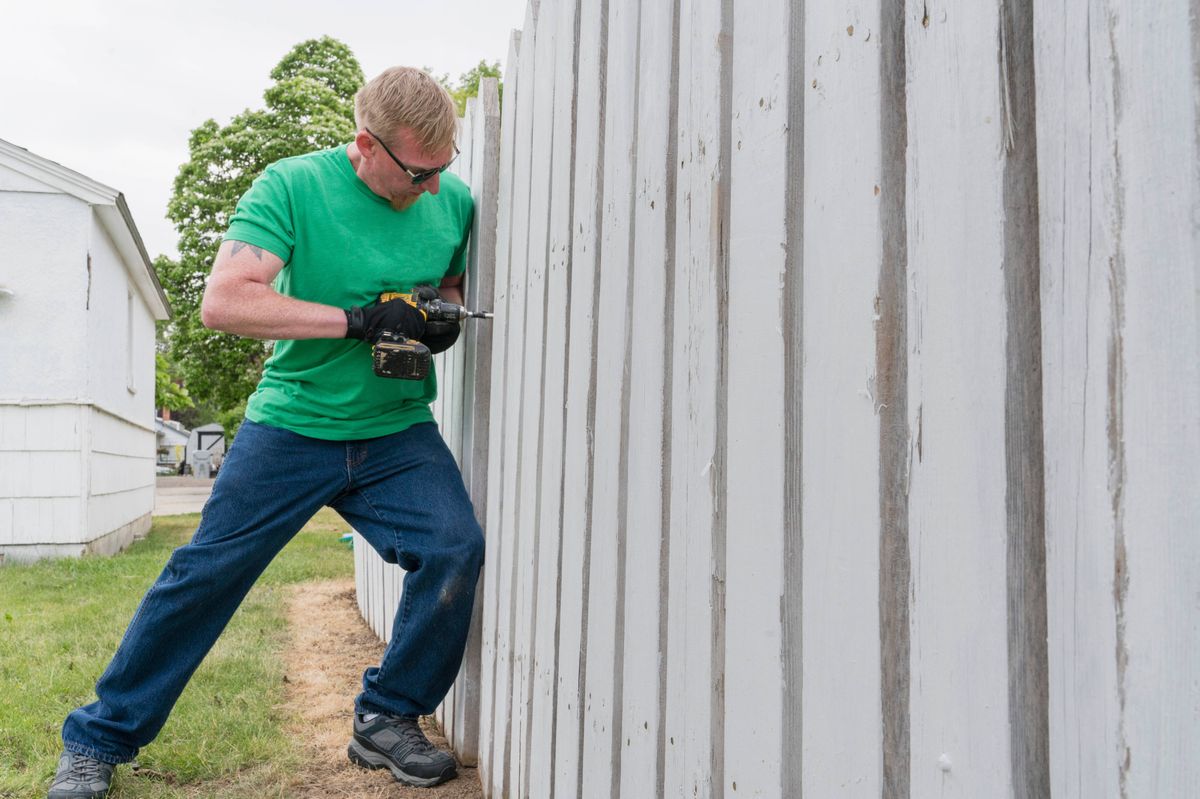 Man repairing a fence