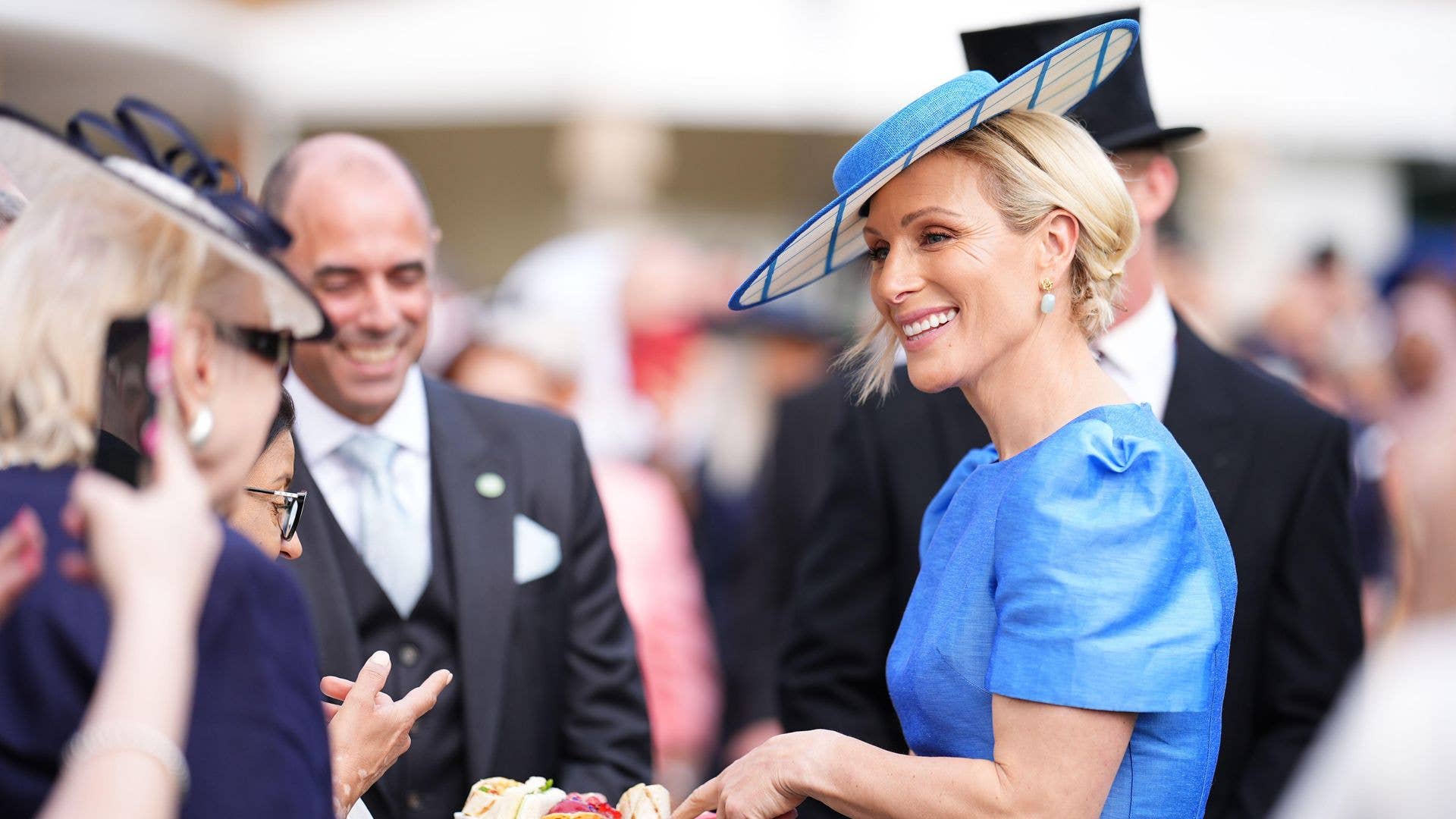 Zara Tindall speaking to people at a garden party