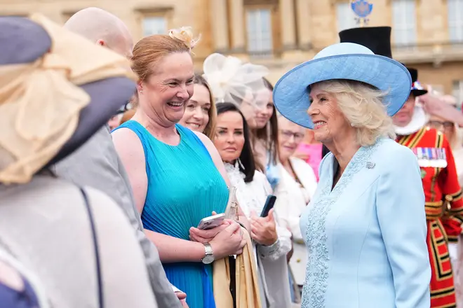 Britain's Queen Camilla talks to guests during a Royal Garden Party at Buckingham Palace
