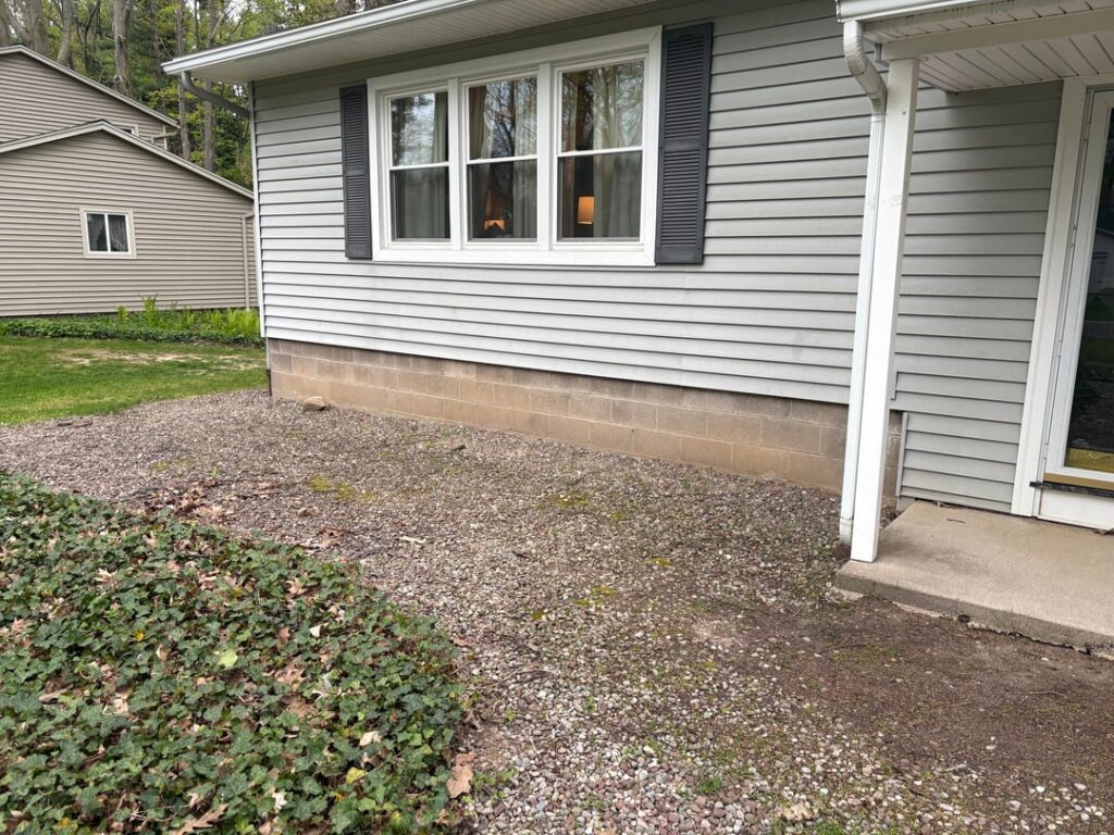 Can I cover stone with 4" of topsoil and plant grass? Upstate ny.