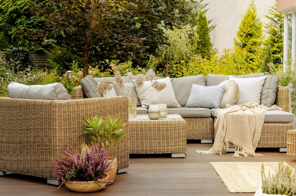 Wicker furniture on a wooden terrace of modern house