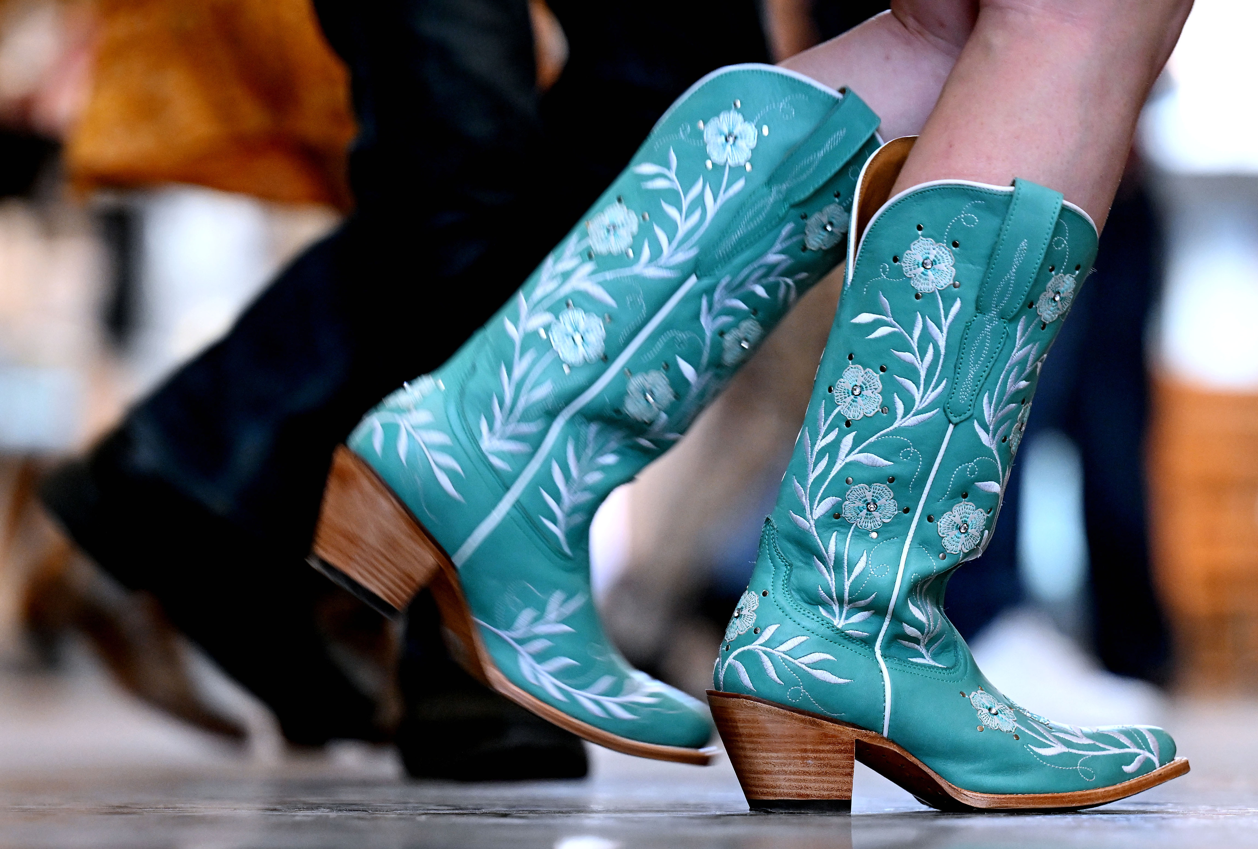 Kyrin Alexander line dances in her new Ariat boots during...
