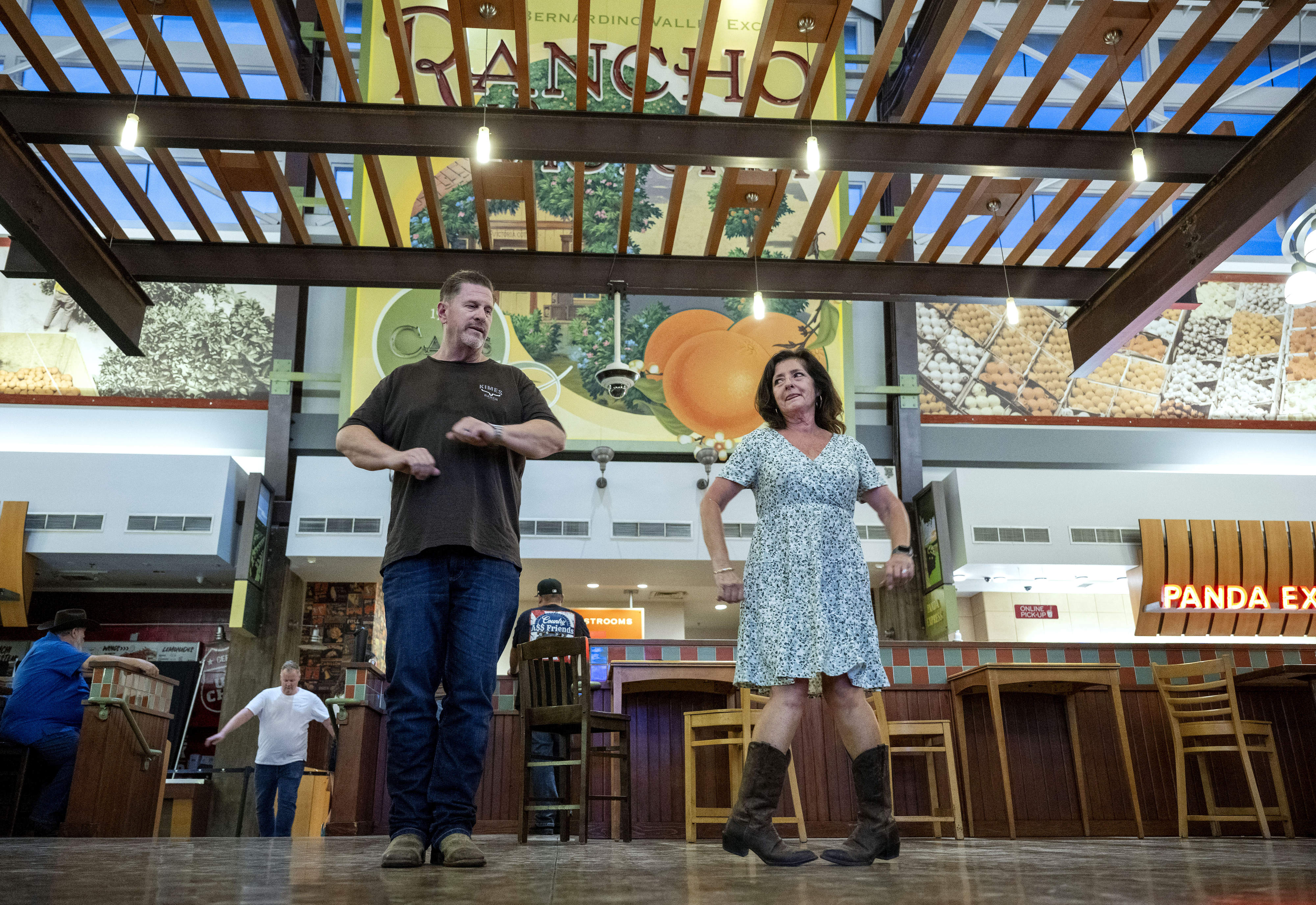 Ron and Trish Curl, both from Fontana, line dance during...
