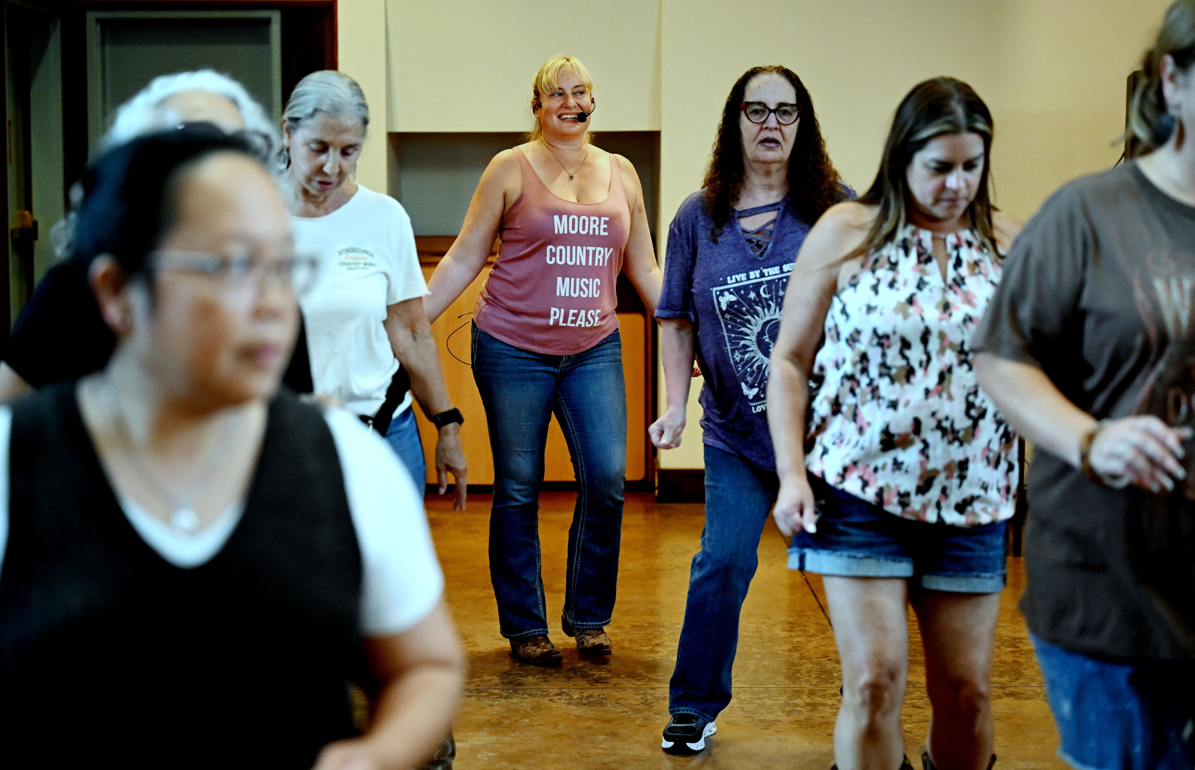 Pepper McDonel, center, teaches line dancing during Victoria Gardens Western...