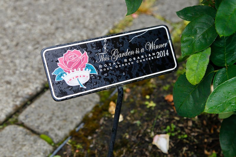 plaque in a garden that reads This Garden in a Winner with an image of a rose and crown