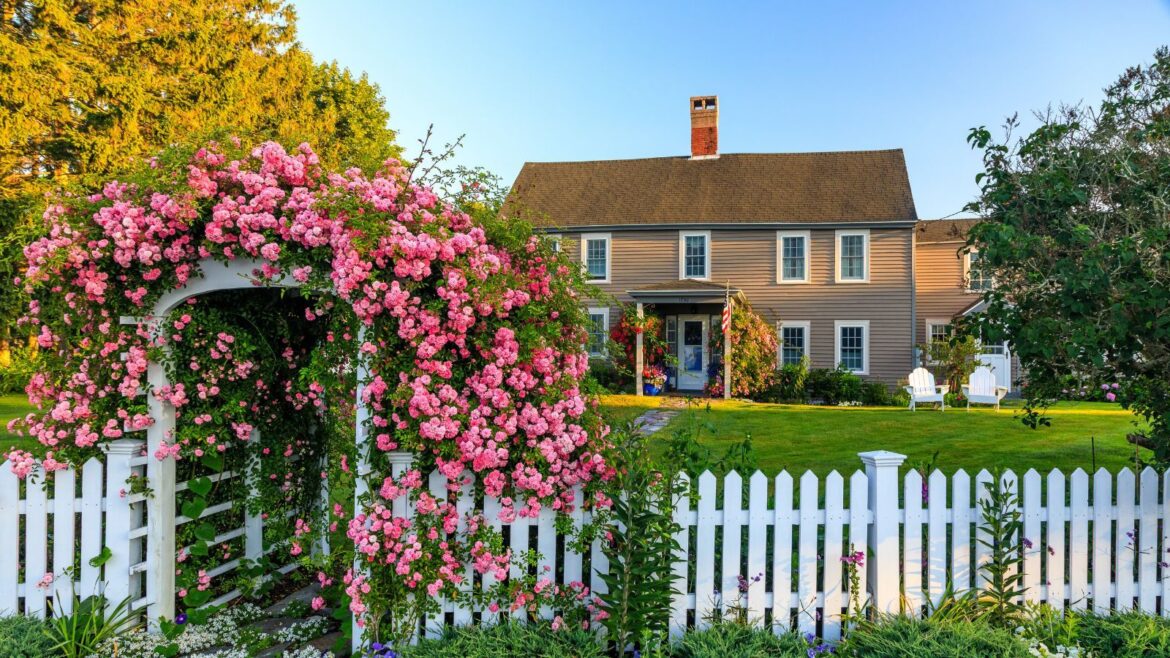 These Fence Colors Will Make Your Home Look More Expensive White fence in large backyard of colonial-style home