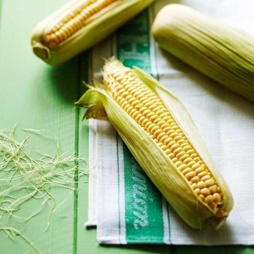 sweetcorn on cloth on table fresh corn on the cob arranged on a linen cloth