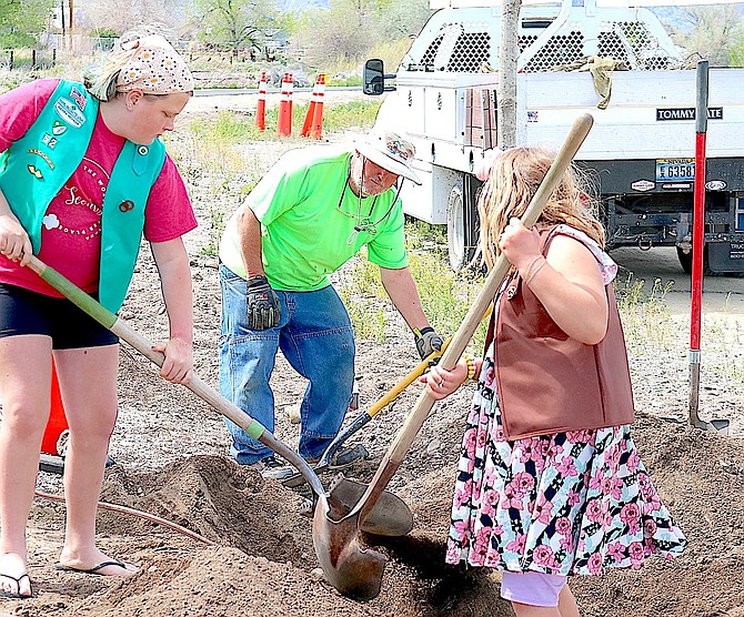Members of Troop 52 help Gardnerville staff plant trees along Mountain View Pond on Arbor Day.