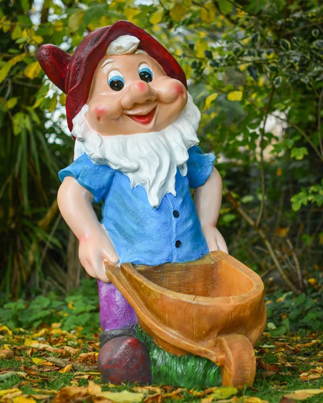 Garden gnome holding a wheelbarrow.