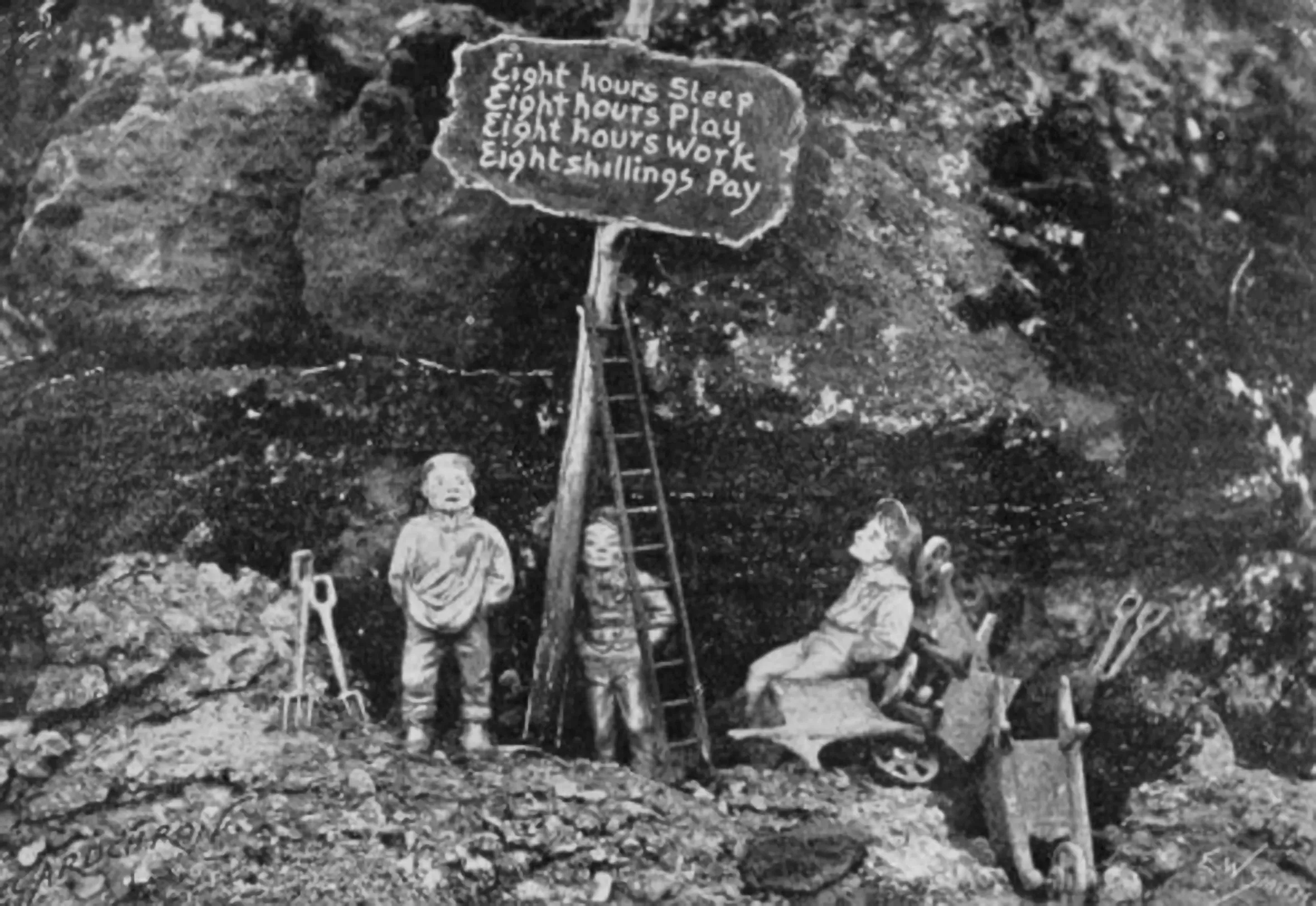 Gnomes at Lamport Hall representing miners on strike in 1897 with a sign reading "Eight hours Sleep, Eight hours Play, Eight hours Work, Eight shillings Pay."