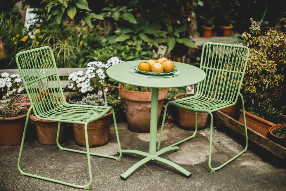 green garden furniture in a small garden. green garden furniture in a small garden.