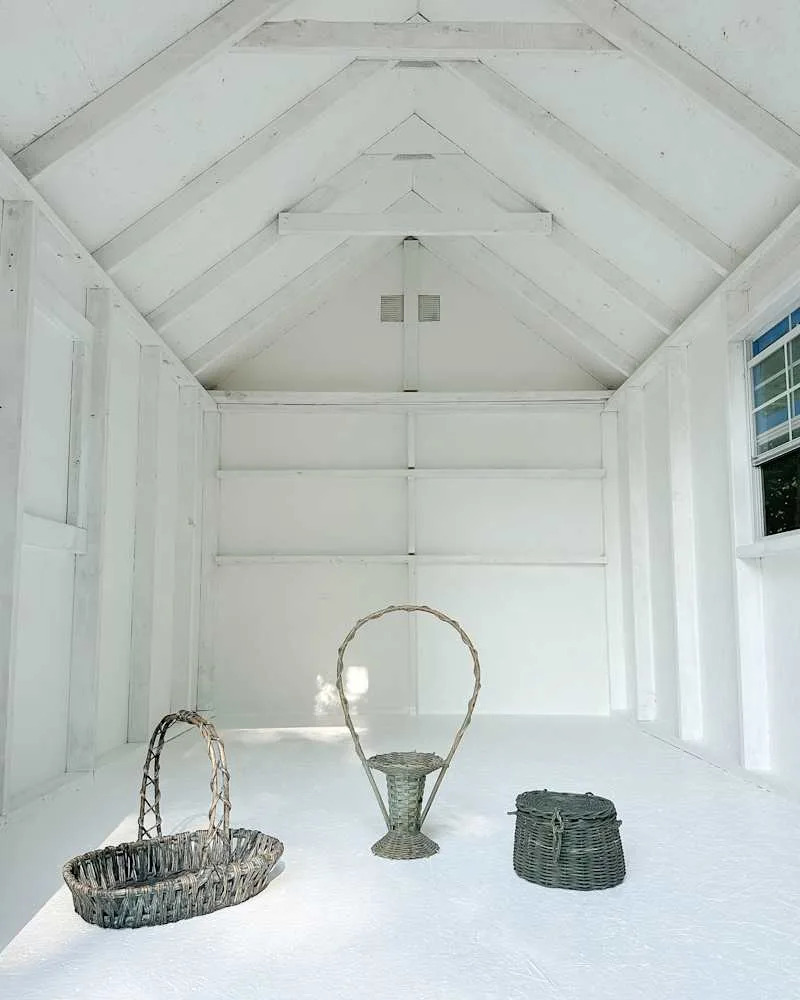 Three woven baskets in a bright, empty room with white walls and a sloped ceiling.
