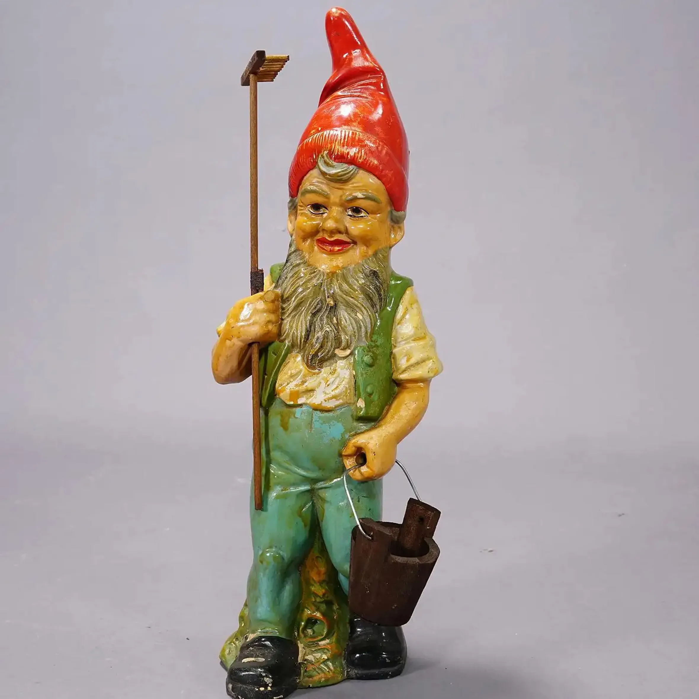 Vintage Heissner Terracotta Garden Gnome from Germany, circa 1950s, holding a rake and a bucket.