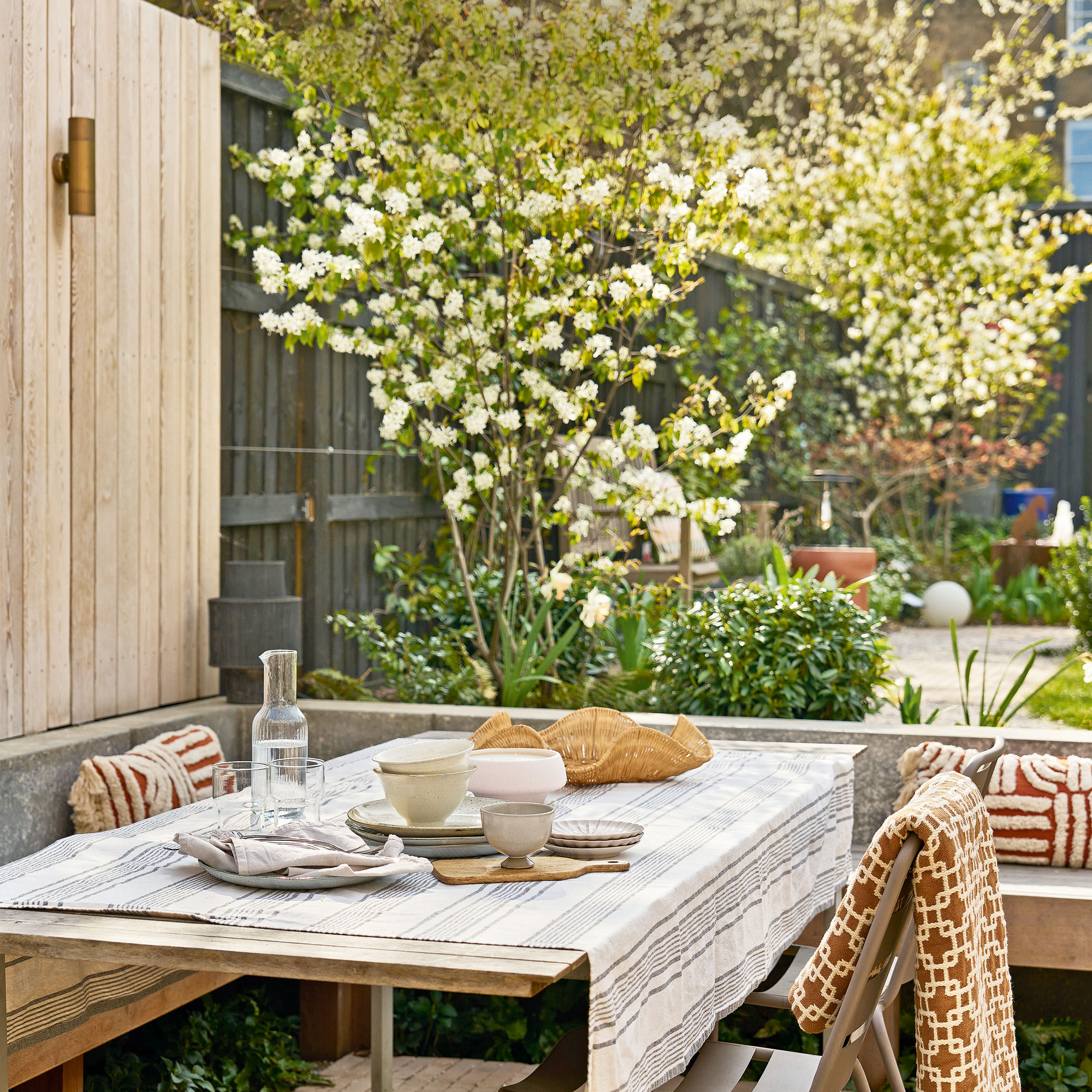 Wooden clad wall, table with built in seating and blankets