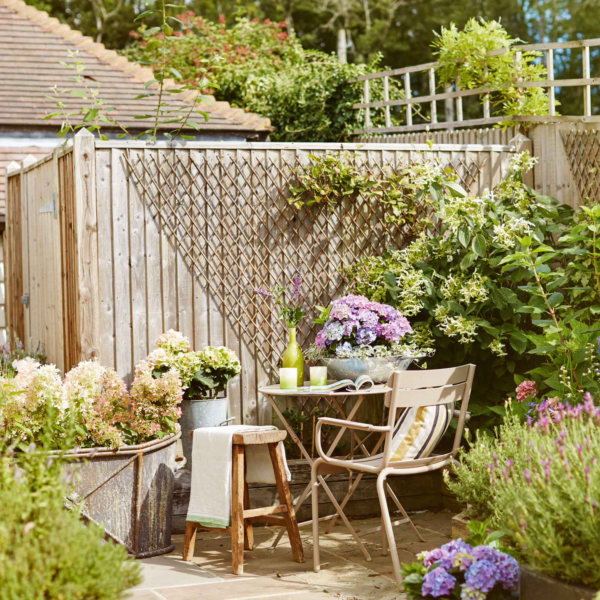 Wooden fence with pergola, small bistro table chair and stool