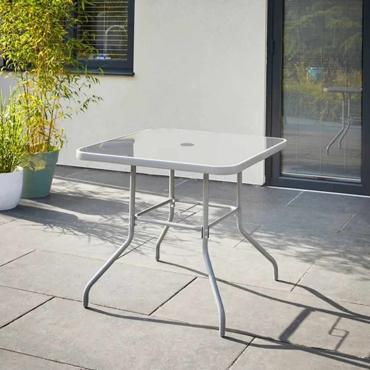 The table of the 6 Piece Metal Garden Dining Set