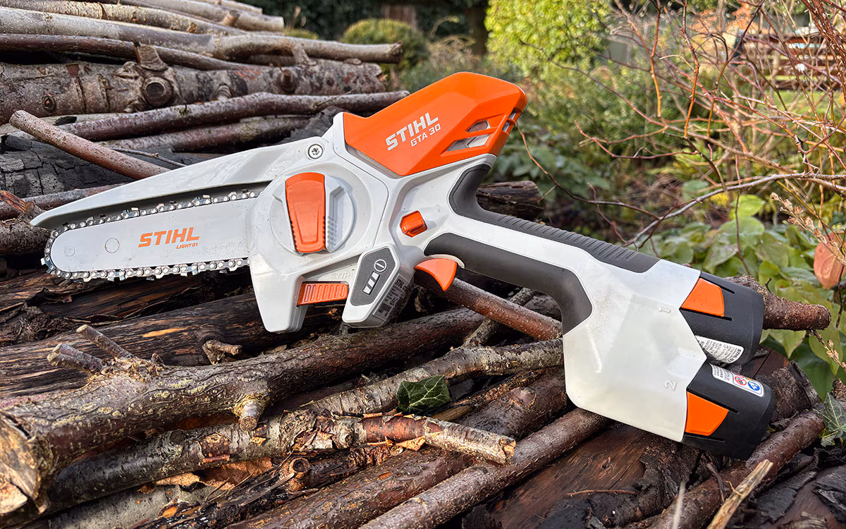 The STIHL GTA 30 cordless pruner on a log pile