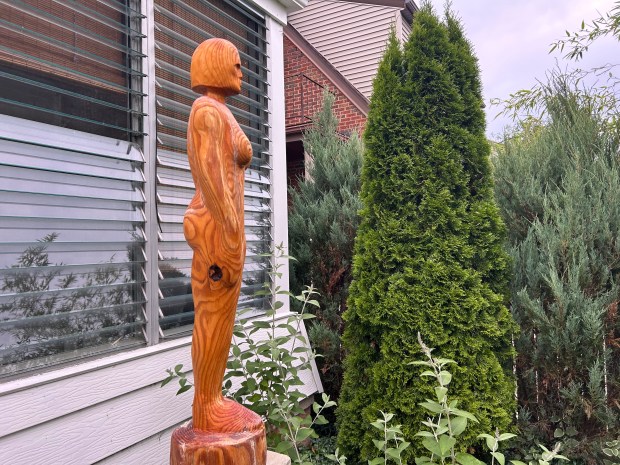 A statue made out of a telephone pole by Tom Evert stands guard in his backyard in Euclid. (Frank Mecham- The News-Herald)